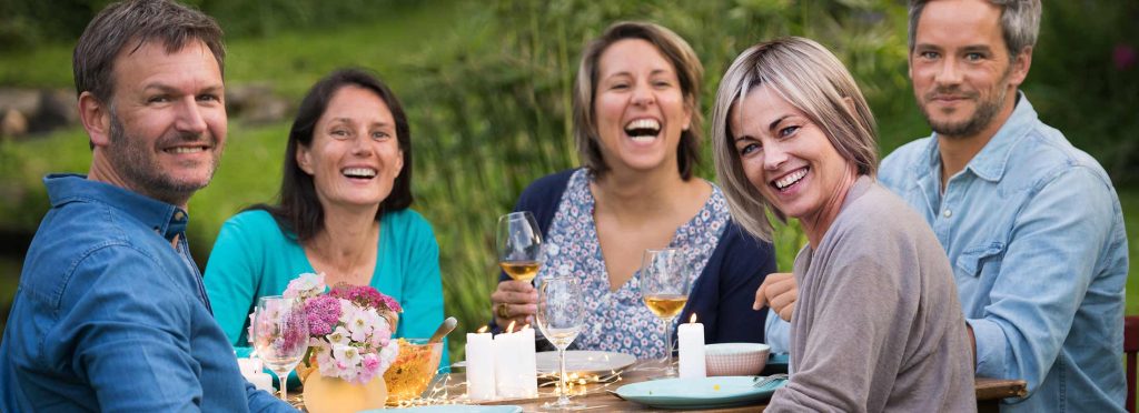 group of friends gathering around picnic table